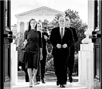  ?? ERIN SCHAFF/THE NEW YORK TIMES ?? With the Supreme Court in the background, Amy Coney Barrett and Vice President Mike Pence enter the Capitol on Tuesday.