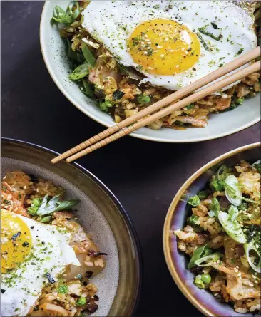  ?? MILK STREET VIA AP ?? This image released by Milk Street shows a recipe for Kimchi and bacon fried rice, topped with a fried egg and sprinkled with furikake.