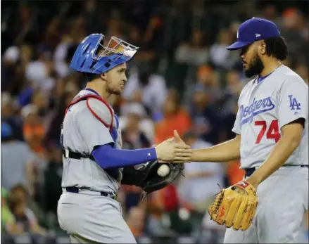  ?? PAUL SANCYA — THE ASSOCIATED PRESS ?? Los Angeles Dodgers relief pitcher Kenley Jansen (74) and catcher Yasmani Grandal celebrate after the final out against the Detroit Tigers in the ninth inning of a baseball game in Detroit on Friday.