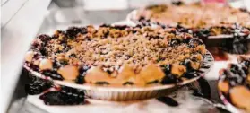  ?? Michael Short / Special to The Chronicle ?? Blackberry Crumble pies cool on a rack at Three Babes Bakeshop in S.F.