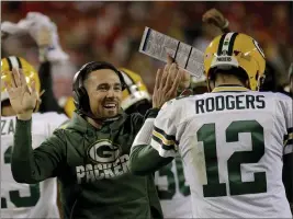  ?? CHARLIE RIEDEL — THE ASSOCIATED PRESS FILE ?? Packers head coach Matt LaFleur celebrates with quarterbac­k Aaron Rodgers (12) after a touchdown during a game against Kansas City.