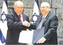  ?? (Ronen Zvulun/Reuters) ?? PRESIDENT REUVEN RIVLIN entrusts Prime Minister Benjamin Netanyahu with the forming of the government after the April election.