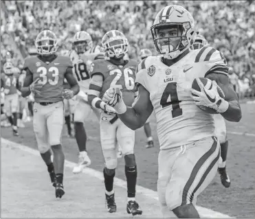  ?? MATTHEW HINTON/AP PHOTO ?? LSU running back Nick Brossette (4) scores a touchdown against against Georgia during the second half of Saturday’s SEC showdown in Baton Rouge, La. The No. 13 Tigers upset the No. 2 Bulldogs 36-16.