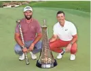  ?? ANDREW REDINGTON/GETTY IMAGES ?? Jon Rahm, left, won the DP World Tour Championsh­ip trophy and Rory McIlroy the Harry Vardon points trophy.