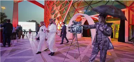  ??  ?? Reel for real: A mime actor standing behind a model vintage cinema camera at the entrance of the AMC cinema in Riyadh ahead of the first film screening in over three decades. — AFP