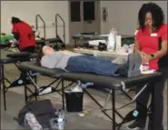  ??  ?? People lay down as they donate blood during a drive hosted by the Montgomery County Community College west campus. The blood drive was combined with a wellness fair.