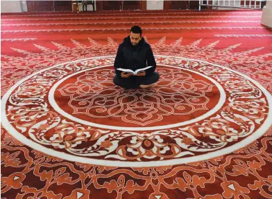  ?? Acting UK deputy permanent representa­tive to UN
AFP ?? We are deeply concerned by reports that the new Israeli government coalition has reached an agreement which paves the way for annexation of parts of the West Bank.
James Roscoe
A Palestinia­n muezzin reads the Holy Qur’an in an almost empty mosque in Gaza
City during the first Friday prayers of the holy month.