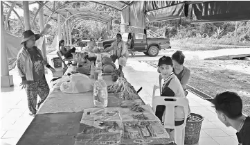  ??  ?? Rumah Emak Libau residents wait for customers in comfort at the new stalls.