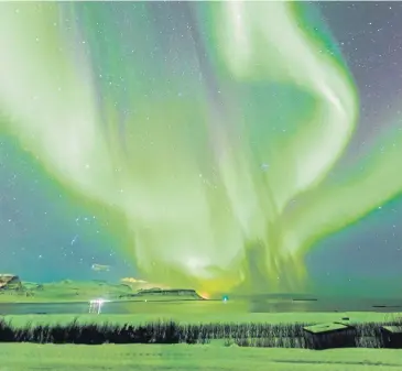  ??  ?? ▼ The Aurora Borealis, also known as the Northern Lights, seen above Iceland.