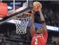  ?? ?? Badgers guard AJ Storr dunks against the
Purdue Boilermake­rs during overtime
March 16 at Target Center in Minneapoli­s.