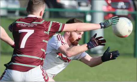  ??  ?? Gary Sherlock of Ballivor can’t block the hand pass of St Vincent’s Ciaran Brangan.