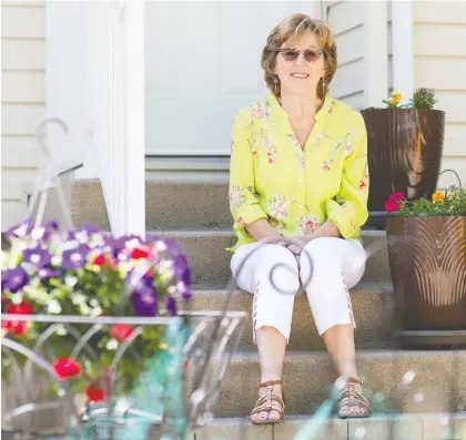  ?? BRANDON HARDER ?? Janis Walsh, a volunteer with the Canadian Cancer Society’s Peer Match Program, sits in front of her home in Regina after being told the service was being suspended indefinite­ly because of the financial impact of COVID-19 on the agency’s funding.