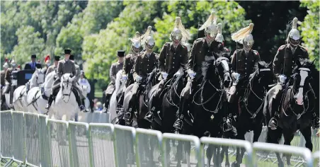  ?? THE ASSOCIATED PRESS ?? A carriage procession moves along the Long Walk at Windsor Castle during a rehearsal on Thursday for Saturday’s wedding of Prince Harry and Meghan Markle.