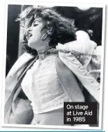  ??  ?? On stage at Live Aid in 1985