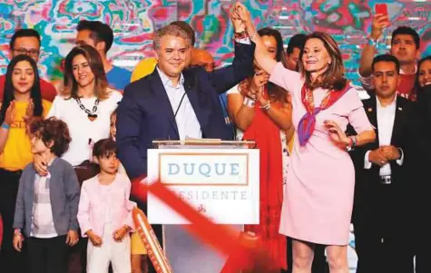  ?? Reuters ?? Right wing presidenti­al candidate Ivan Duque holds the hand of his vice-presidenti­al candidate Marta Lucia Ramirez after polls closed in the first round of the presidenti­al election in Bogota, Colombia on Sunday.