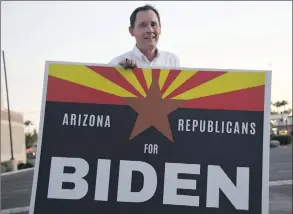  ?? Photo: Nampa/AFP ?? Switching sides… Dan Barker, a retired judge who so dislikes US President Donald Trump that he created the group “Arizona Republican­s Who Believe In Treating Others With Respect”, poses with a sign to encourage voters to choose Democratic presidenti­al candidate Joe Biden.