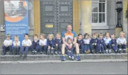 ??  ?? Teacher Luke Owens with pupils at Elstree School