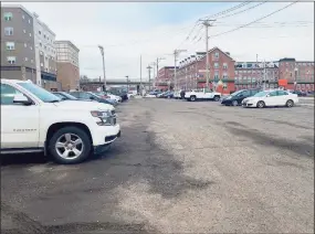  ?? Brian Gioiele / Hearst Connecticu­t Media ?? Developer John Guedes has proposed constructi­on of a four-story building, with first-floor commercial and three floors of apartments on what was the former Chromium Procession site on Canal Street. The land is presently used for parking.