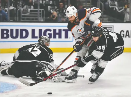  ?? GARY A. VASQUEZ/USA TODAY SPORTS ?? Kings centre Blake Lizotte helps goalie Jonathan Quick defend against Oilers winger Zack Kassian during Game 4 of their first-round NHL playoff series at Crypto.com Arena on Sunday night. The Kings won the game 4-0 to tie the series 2-2.