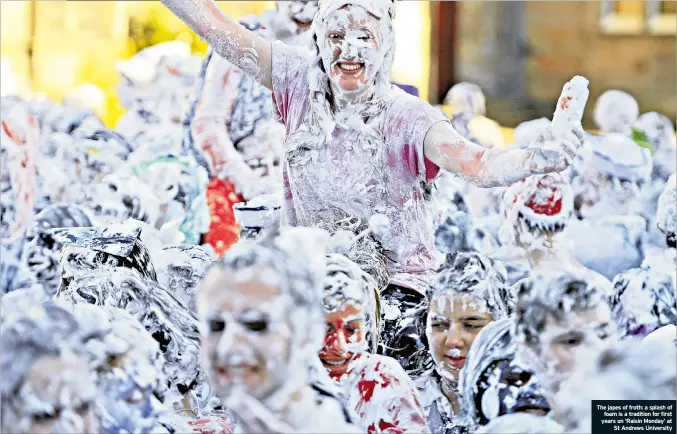  ??  ?? The japes of froth: a splash offoam is a tradition for first years on ‘Raisin Monday’ atSt Andrews University