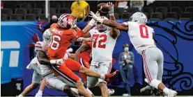  ?? GERALD HERBERT/AP ?? Clemson’s Trevor Lawrence tries to pass during the second half against Ohio State in the Sugar Bowl on Friday at Mercedes-Benz Superdome in New Orleans.