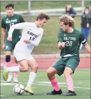  ?? Arnold Gold / Hearst Connecticu­t Media ?? Xavier’s Ryan Gerry, left, and Guilford’s Aidan Buchanan battle for the ball in Guilford in 2020.