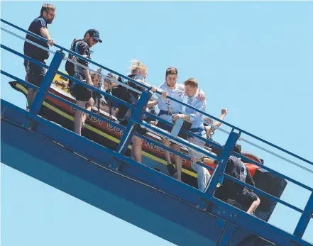  ?? Picture: ADAM HEAD ?? Riders got more thrills than they bargained for when a cart on Sea World’s Storm Coaster ground to a halt.
