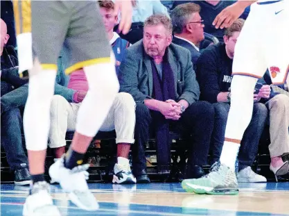  ??  ?? In this March 6, 2020, file photo, New York Knicks owner James Dolan (centre) watches the first half of an NBA basketball game between the Knicks and the Oklahoma City Thunder at Madison Square Garden in New York. Dolan, the executive chairman of Madison Square Garden Company and owner of the Knicks, has tested positive for the coronaviru­s.