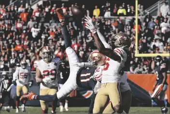  ?? DAVID BANKS/AP ?? SAN FRANCISCO 49ERS CORNERBACK JOSH NORMAN (26) intercepts a Chicago Bears quarterbac­k Justin Fields’ pass intended for wide receiver Darnell Mooney (11) during the second half of a game Sunday in Chicago.