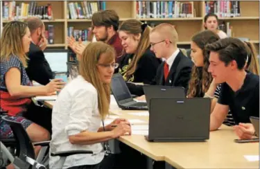  ?? PHOTO PROVIDED ?? Ballston Spa High School seniors present their culminatin­g projects to faculty at the annual Seal of Biliteracy showcase.