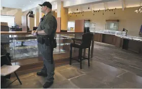  ??  ?? An armed guard keeps Witter Coins secure considerin­g it temporaril­y has a $1 million Gold Rush coin and many other rare and valuable currency on display.