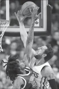  ?? FRANK GUNN, THE CANADIAN PRESS ?? Toronto Raptors centre Lucas Nogueira, left, blocks Charlotte Hornets guard Marco Belinelli on his dunk attempt during first-half action in Toronto on Wednesday. The Raptors won 100-95. LORI EWING