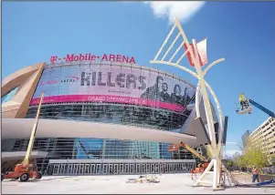  ?? JOHN LOCHER/THE ASSOCIATED PRESS ?? Workers finish constructi­on on T-Mobile Arena in Las Vegas, Nev., on Monday. MGM officials think they will hit the jackpot with the new $375 million arena on the Strip.