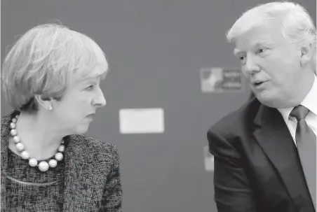  ?? MATT DUNHAM, AP, POOL ?? U.S. President Donald Trump speaks with British Prime Minister Theresa May during a working dinner in May at NATO’s headquarte­rs in Brussels. May was the first world leader to meet with Trump after he took office in January.