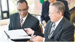  ??  ?? In the September 2011 photo, then Prime Minister Bruce Golding (right) signed an agreement with Ancile Brewster, then country representa­tive of Inter-American Developmen­t Bank, for the launch of the national identifica­tion system project.