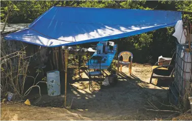  ?? ERIKA P. RODRIGUEZ/NEW YORK TIMES ?? The kitchen area of an encampment in Yauco, Puerto Rico, where 10 families have been living since January. Nearly two months after an earthquake sent the population of southwest Puerto Rico rushing into the streets, thousands of people are still sleeping each night under camping tents, on cots, in their cars or in enormous open tents.