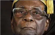  ?? BEN CURTIS — THE ASSOCIATED PRESS FILE ?? Zimbabwe’s President Robert Mugabe officiates at a student graduation ceremony at Zimbabwe Open University on the outskirts of Harare, Zimbabwe. On Friday Zimbabwe President Emmerson Mnangagwa said his predecesso­r Robert Mugabe, age 95, has died.