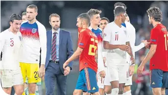  ??  ?? Gareth Southgate with his players after the victory in Spain