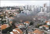  ?? Tsafrir Abayov Associated Press ?? ON OCT. 7, smoke rises after a rocket fired from the Gaza Strip hit a house in Ashkelon in southern Israel.