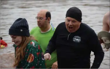 ?? Marian Dennis — Digital First Media ?? Participan­ts, including Pottstown School Board member Raymond Rose in the black body suit, reacted to the 45-degree water as they took the annual dip into the Schuylkill River for the Polar Bear Plunge in Pottstown’s Riverfront Park.