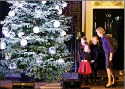  ??  ?? Fun: The girls joined Mrs May to turn on No10’s lights yesterday