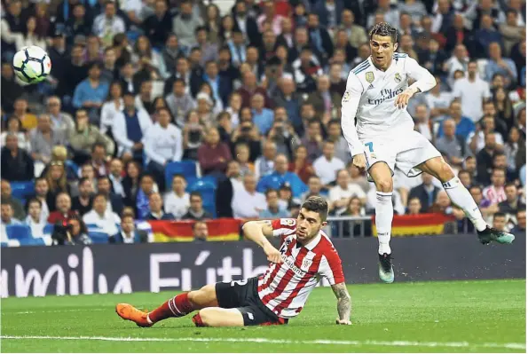  ??  ?? Having a blast: Real Madrid’s Cristiano Ronaldo taking a shot at goal as Athletic Bilbao’s Unai Nunez tries to block in the La Liga match on Wednesday.