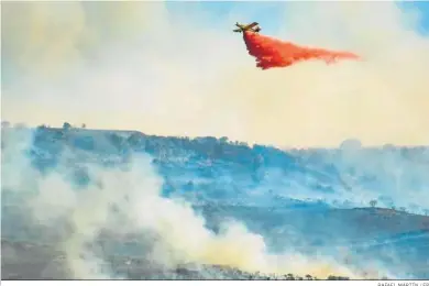  ?? RAFAEL MARTÍN / EP ?? Un helicópter­o trabaja ayer en la extinción del incendio provocado en Chiloeches (Guadalajar­a).