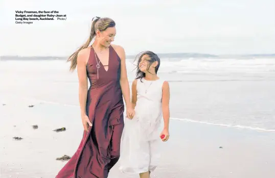  ?? Getty Images Photo / ?? Vicky Freeman, the face of the Budget, and daughter Ruby-Jean at Long Bay beach, Auckland.