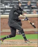  ?? Ap-mary Altaffer ?? Atlanta’s Billy Hamilton hits an RBI single during the 14th inning of the team’s baseball game against the New York Mets on Friday in New York.