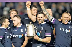  ??  ?? Victorious: Scotland captain John Barclay and his team-mates celebrate with the Calcutta Cup