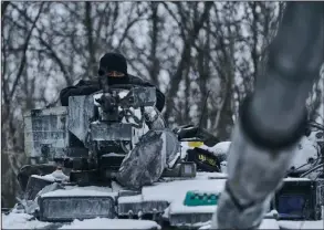  ?? (AP/Libkos) ?? A Ukrainian tank is rolled to its front-line position in Bakhmut in the Donetsk region of Ukraine on Sunday. Cities throughout Ukraine were bombarded by Russian forces during the weekend.