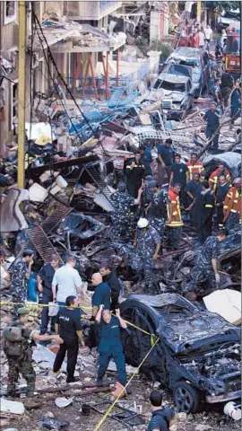  ?? Bilal Hussein Associated Press ?? LEBANESE SOLDIERS inspect the damage from the bombing in the Achrafieh district. The violence recalled for many the chaos of Lebanon’s 15-year civil war.