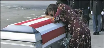  ?? The Associated Press ?? TEARS: In this frame from video taken Tuesday, Myeshia Johnson cries over the casket of her husband, Sgt. La David Johnson, who was killed in an ambush in Niger, upon his body’s arrival in Miami. President Donald Trump told the widow that her husband...