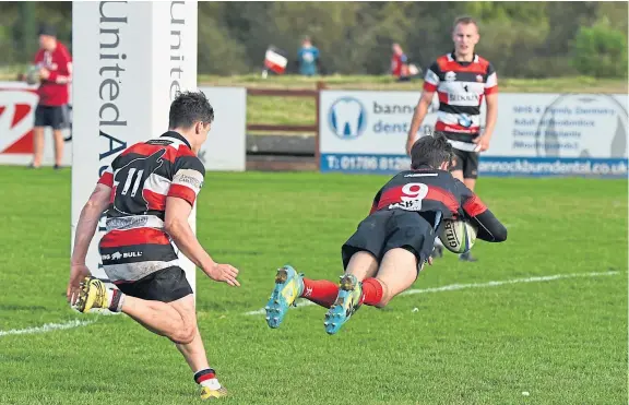  ?? Picture: Jon Mussen. ?? Finlay Jacobs dives over the line for his try in Dundee High’s defeat away to Stirling.